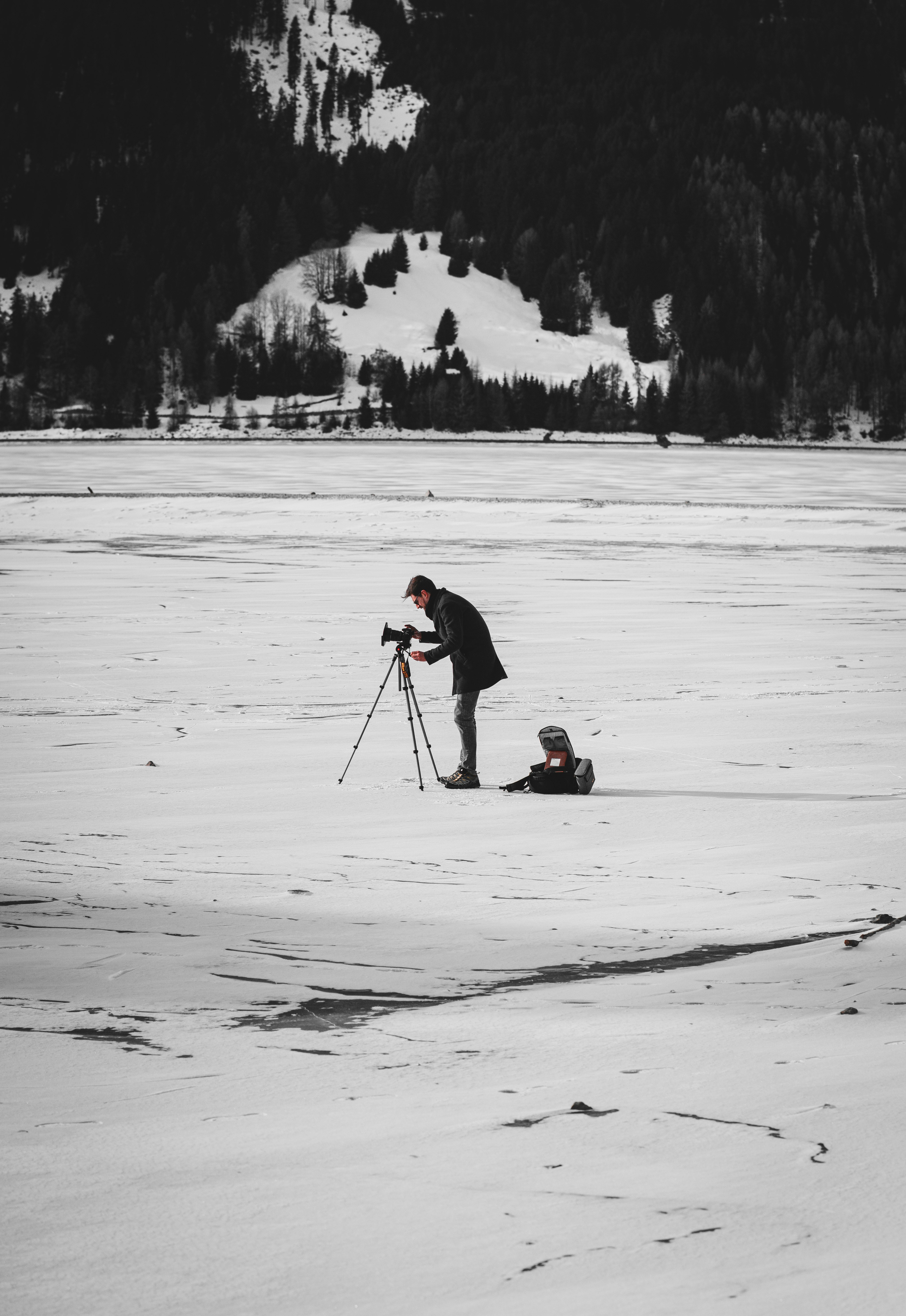 person in red jacket and black pants riding on snow board on snow covered field during